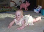 Four months, ready to move. She's rolling around the room now.  She heads for Chris and his toys.