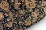 Baltic Brown Granite.  Light brown, green and black are the predominate colors.  I like the "hazel eyes" look of the inclusions.
