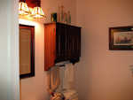 The bathroom is finally finished.  I found a closed cabinet with a towel bar, a nice dark framed mirror and lights mounted on dark wood.  I like the contrasts.