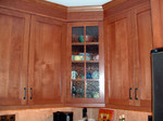 Glass in the cabinets.  Seeded glass, gives a view without seeing the mess