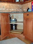 I have two corner cabinets like this, no susans, super or lazy - just shelves for all the big stuff that used to be in the basement.  I like the design, it's not blind, there are no hidden corners, and the door is big.