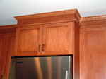 The crown moulding at the top of the fridge.  It's three separate pieces, finishes off the cabinets nicely, and no soffitt.