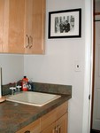 Other side of (very small) laundry room.  The sink is a Swan laundry sink.  I put a Rev-A-Shelf pull out trash can under the sink, wonderful invention.  The cats are fed in here, it's easy to keep the floor clean now.  With the stacked W/D they can now go out using the door in the laundry room.  Big improvement.