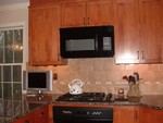 The cabinet over the microwave has been cut down, and reinstalled, so the MW is now the correct height. The light rails are now installed under the cabinets.  The microwave is Dacor OTR PMOR30.  The cooktop is the Dacor PGM304.  I had a gas line run to the house just for the gas cooktop.  I love it.